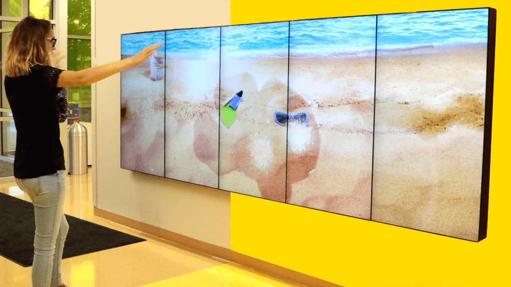 Women uses an Active Play wall.