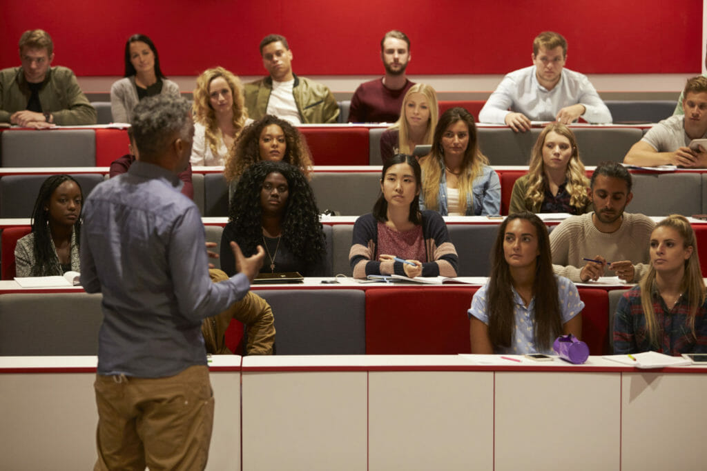 A professor lectures a group of students.