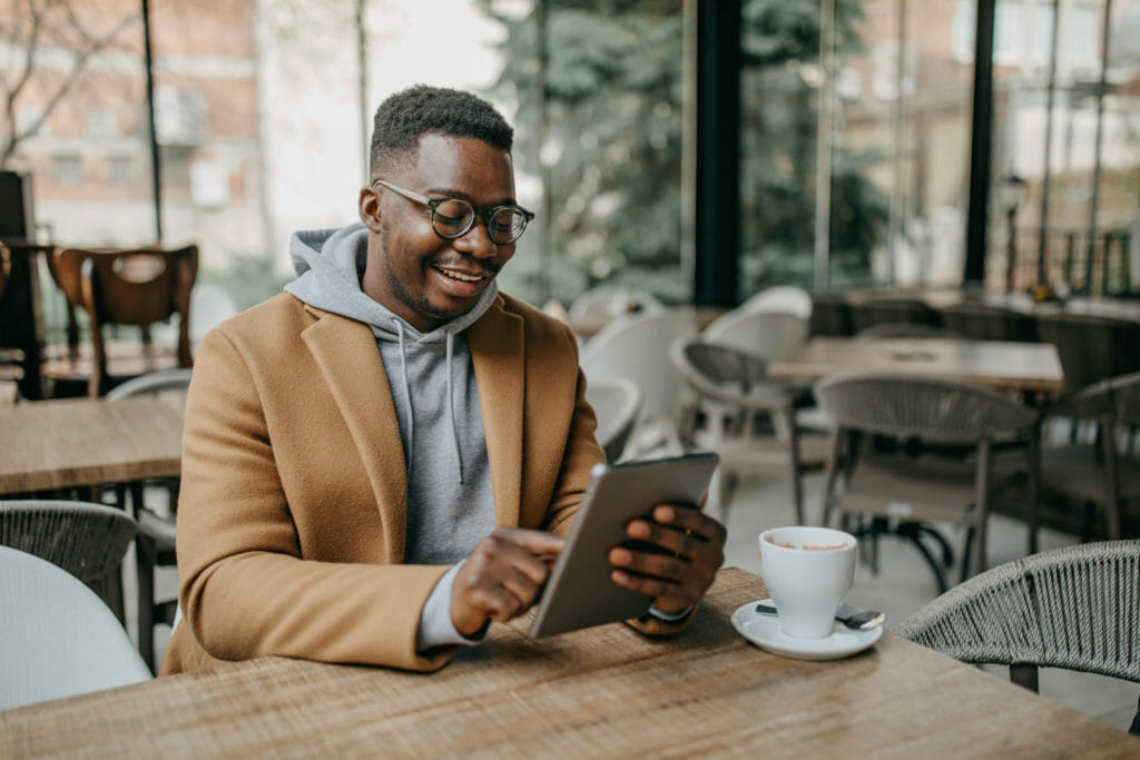 An employee works remotely from a coffee shop.