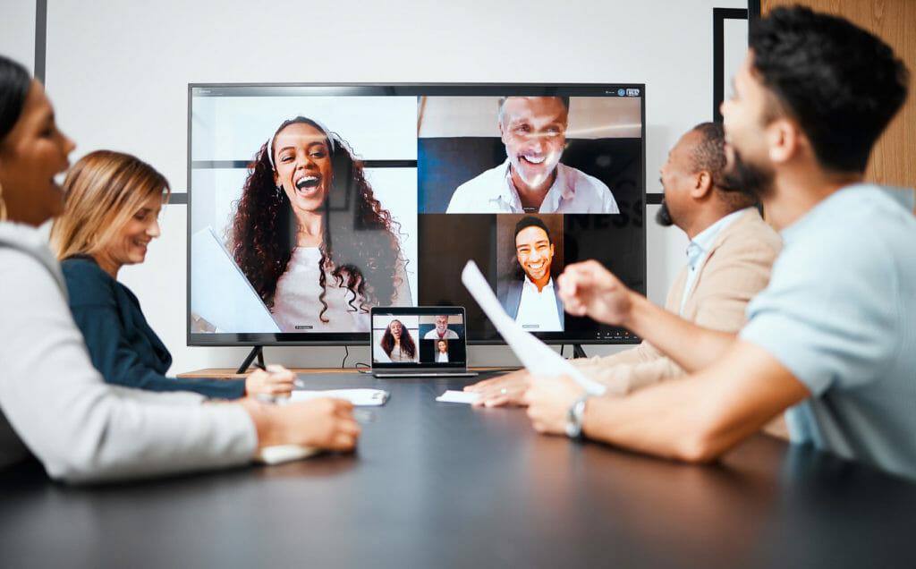 Employees video chat with co workers.